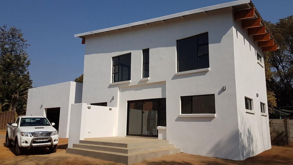 Completed white double-storey home with double garage in Pretoria
